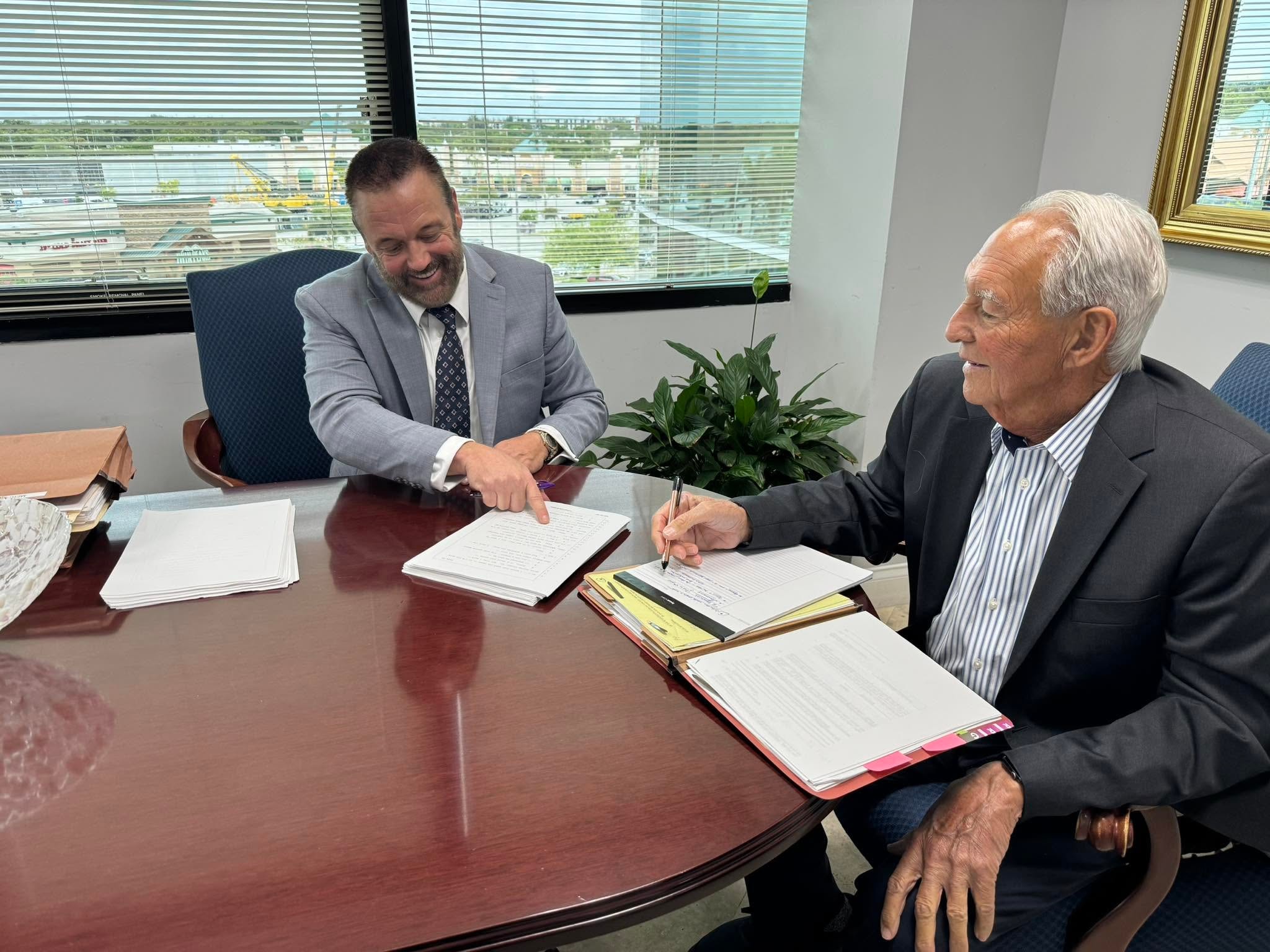 Glenn Roderman and Philip Johnston reviewing case files at the Roderman & Johnston office